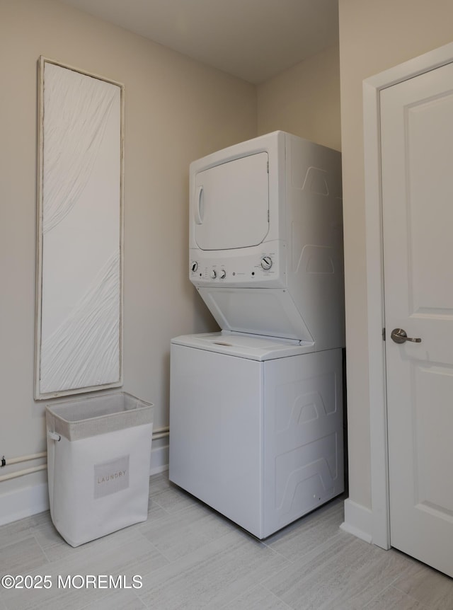 28202 Radford Ct, Monroe, NJ 08831 - laundry area featuring stacked washer / drying machine and baseboards