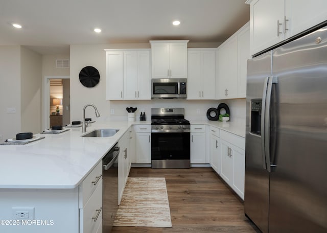 28202 Radford Ct, Monroe, NJ 08831 - kitchen featuring stainless steel appliances, a peninsula, white cabinets, dark wood-type flooring, and recessed lighting