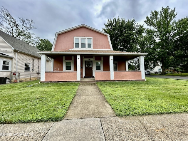 38 Crescent St, Keansburg, NJ 07734 - view of front of home with a porch, a gambrel roof, and stucco siding