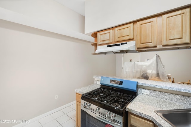 200 Paterson Plank Rd Unit 302, Union City, NJ 07087 - kitchen with gas range, under cabinet range hood, light brown cabinets, and light countertops
