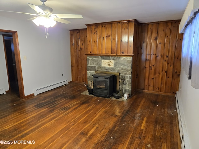 10 Weston Pl, Eatontown, NJ 07724 - unfurnished living room featuring baseboard heating, a baseboard radiator, a ceiling fan, hardwood / wood-style floors, and wooden walls