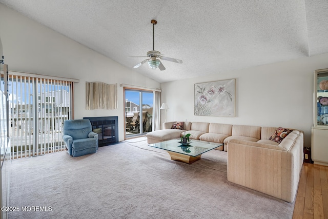 1856 Mill Creek Rd, Beach Haven West, NJ 08050 - living area featuring a textured ceiling, healthy amount of natural light, ceiling fan, vaulted ceiling, and a glass covered fireplace