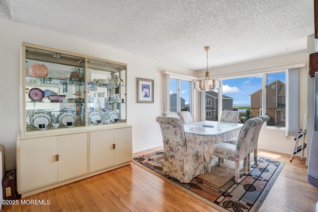 1856 Mill Creek Rd, Beach Haven West, NJ 08050 - dining space featuring a textured ceiling, a chandelier, and light wood-style floors