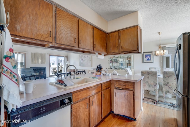 1856 Mill Creek Rd, Beach Haven West, NJ 08050 - kitchen with dishwasher, freestanding refrigerator, light countertops, brown cabinets, and a textured ceiling