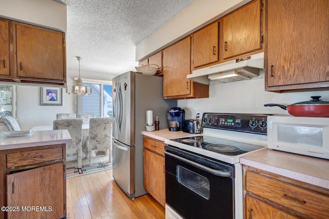 1856 Mill Creek Rd, Beach Haven West, NJ 08050 - kitchen featuring electric range oven, under cabinet range hood, a textured ceiling, light countertops, and brown cabinets