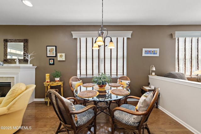 45 Marigold Ln, Little Egg Harbor, NJ 08087 - dining area with plenty of natural light, a chandelier, wood finished floors, and a fireplace