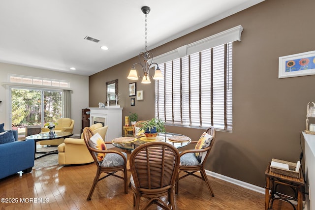 45 Marigold Ln, Little Egg Harbor, NJ 08087 - dining area with wood finished floors, a fireplace, recessed lighting, and a chandelier