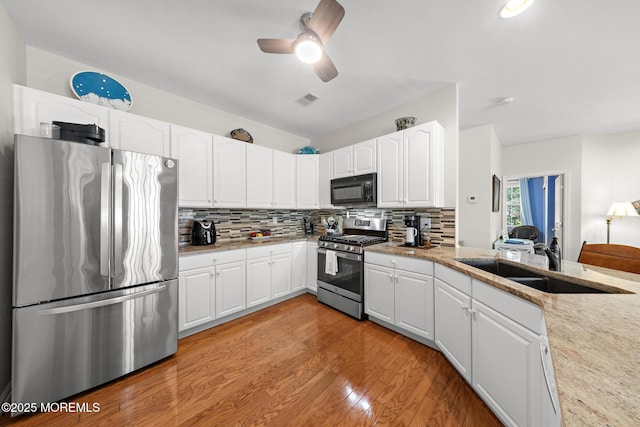 45 Marigold Ln, Little Egg Harbor, NJ 08087 - kitchen with stainless steel appliances, tasteful backsplash, white cabinets, and ceiling fan