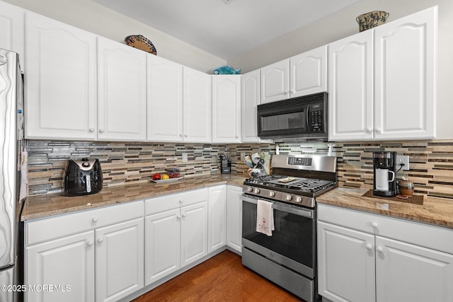 45 Marigold Ln, Little Egg Harbor, NJ 08087 - kitchen with stainless steel appliances, tasteful backsplash, light stone countertops, white cabinets, and light wood-style floors
