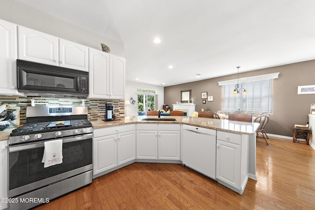45 Marigold Ln, Little Egg Harbor, NJ 08087 - kitchen featuring stainless steel gas range oven, dishwasher, black microwave, a peninsula, and light wood finished floors