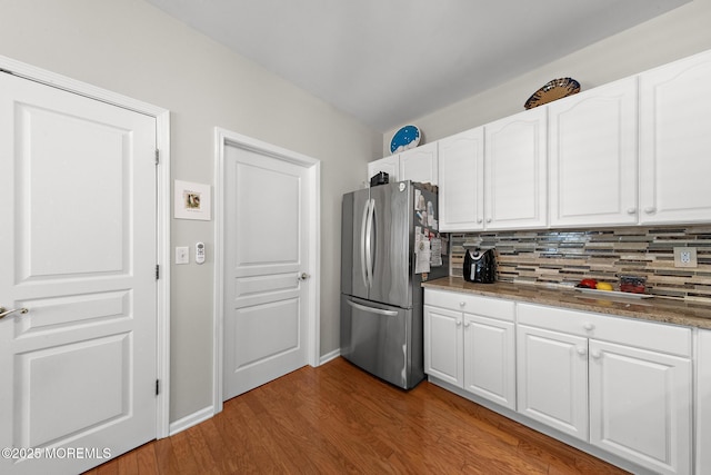 45 Marigold Ln, Little Egg Harbor, NJ 08087 - kitchen featuring freestanding refrigerator, white cabinets, decorative backsplash, and wood finished floors