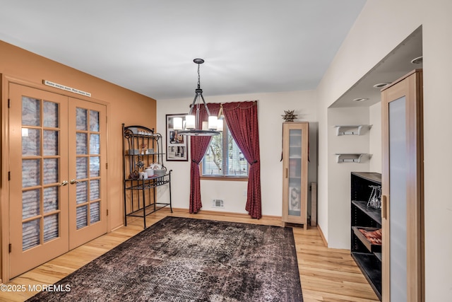 14 Copperfield Ct, Eatontown, NJ 07724 - dining space with a chandelier, wood finished floors, and french doors