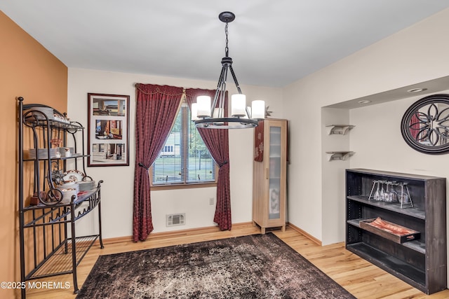 14 Copperfield Ct, Eatontown, NJ 07724 - dining area featuring a chandelier and wood finished floors
