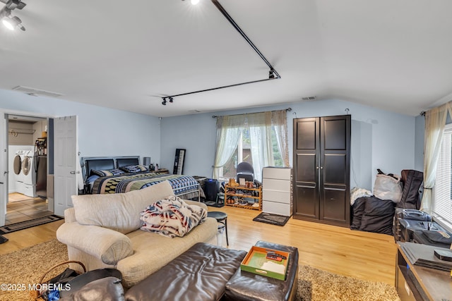 14 Copperfield Ct, Eatontown, NJ 07724 - bedroom with washer and clothes dryer, track lighting, light wood-type flooring, and lofted ceiling