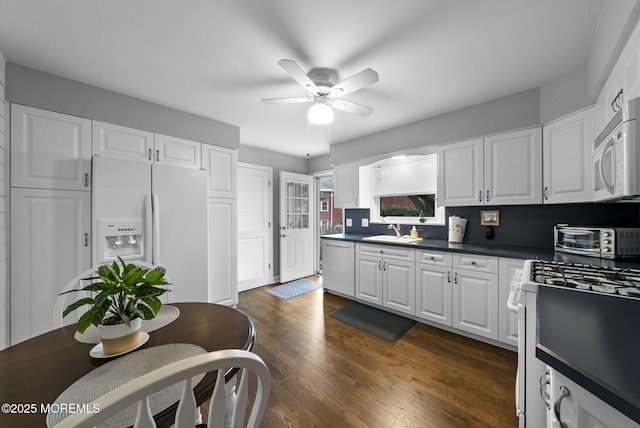 72 Broadway Rd, Freehold, NJ 07728 - kitchen with white appliances, ceiling fan, white cabinetry, dark countertops, and dark wood finished floors