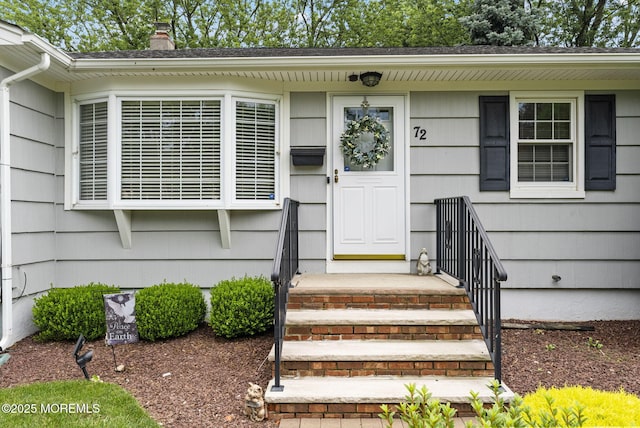72 Broadway Rd, Freehold, NJ 07728 - view of exterior entry featuring a chimney