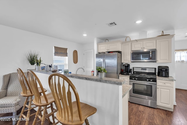 13 Locust St, Highlands, NJ 07732 - kitchen with stainless steel appliances, a breakfast bar, dark wood-style floors, and recessed lighting