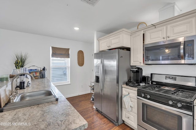 13 Locust St, Highlands, NJ 07732 - kitchen with stainless steel appliances, light countertops, dark wood-style flooring, white cabinetry, and recessed lighting