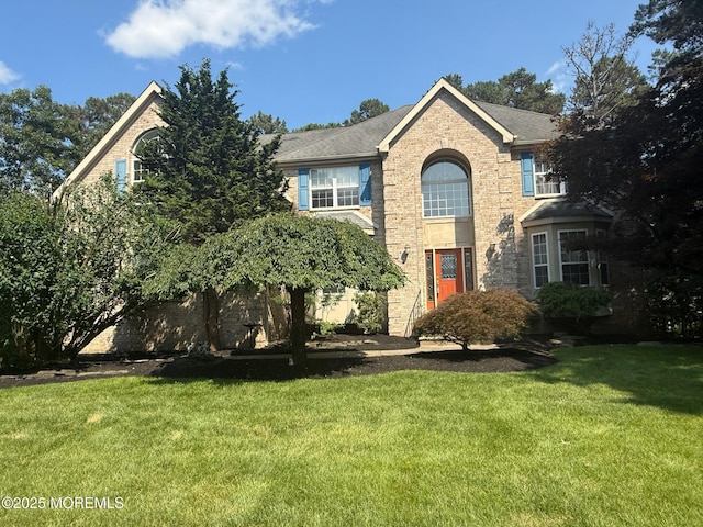 67 Erin Dr, Jackson, NJ 08527 - traditional-style home featuring a front yard and brick siding