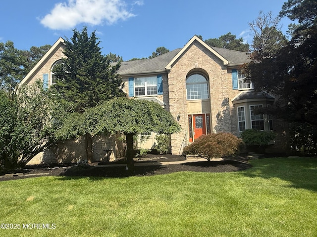 67 Erin Dr, Jackson, NJ 08527 - traditional-style home with a front yard and brick siding