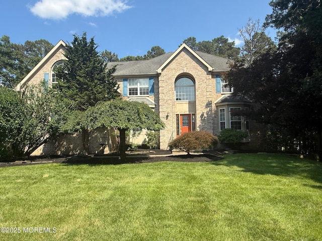 67 Erin Dr, Jackson, NJ 08527 - traditional-style home featuring a front yard and brick siding
