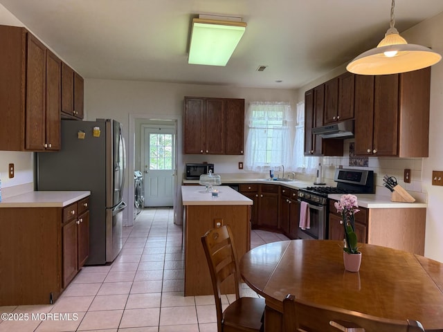 67 Erin Dr, Jackson, NJ 08527 - kitchen featuring stainless steel appliances, under cabinet range hood, a kitchen island, washer / dryer, and light tile patterned flooring