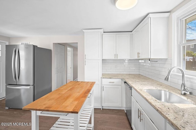 139 Seabreeze Ave, North Middletown, NJ 07748 - kitchen with appliances with stainless steel finishes, white cabinetry, wooden counters, and backsplash