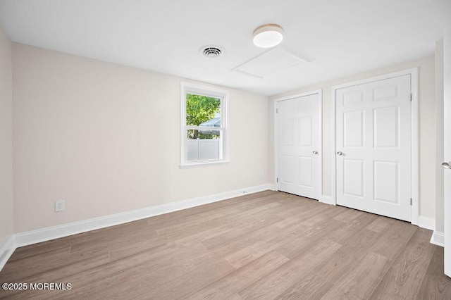 139 Seabreeze Ave, North Middletown, NJ 07748 - unfurnished bedroom with attic access and light wood-style floors