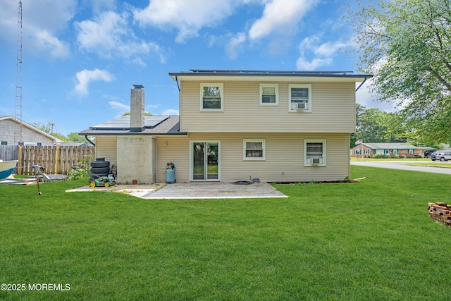 301 6th St, Waretown, NJ 08758 - rear view of house with a patio area, solar panels, and a chimney