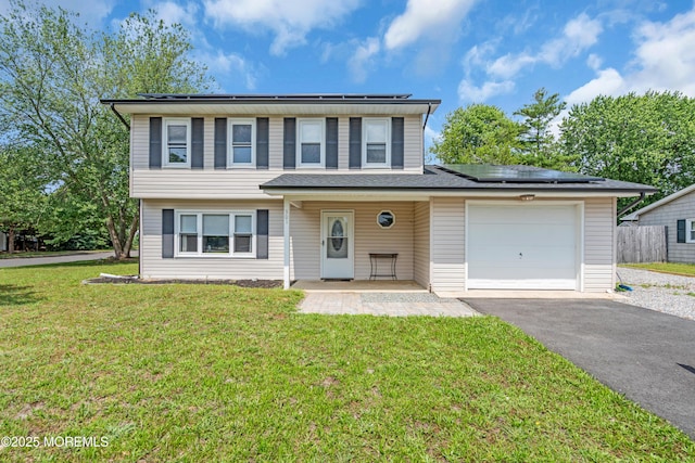 301 6th St, Waretown, NJ 08758 - view of front of house featuring roof mounted solar panels, asphalt driveway, and an attached garage