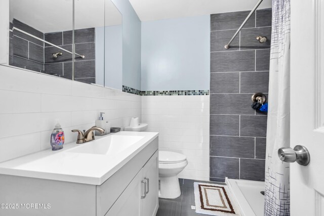 301 6th St, Waretown, NJ 08758 - full bathroom featuring vanity, a shower stall, and tile walls