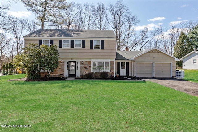 23 Clinton Dr, Manalapan, NJ 07726 - colonial home featuring a garage, asphalt driveway, a front lawn, and stone siding