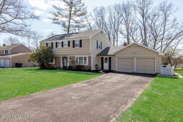 23 Clinton Dr, Manalapan, NJ 07726 - colonial-style house with an attached garage, driveway, stone siding, a front lawn, and a chimney