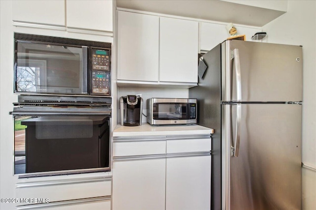 23 Clinton Dr, Manalapan, NJ 07726 - kitchen featuring black appliances, white cabinets, and light countertops