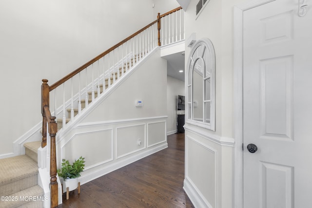 6 Kindling Way, Jackson, NJ 08527 - stairway with wood finished floors, a towering ceiling, and a wainscoted wall