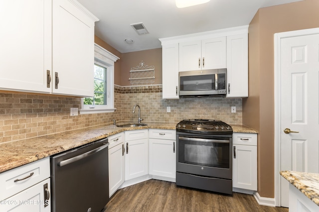 31 Strawberry Ln, Lakewood, NJ 08701 - kitchen featuring stainless steel appliances, dark wood finished floors, white cabinetry, and tasteful backsplash