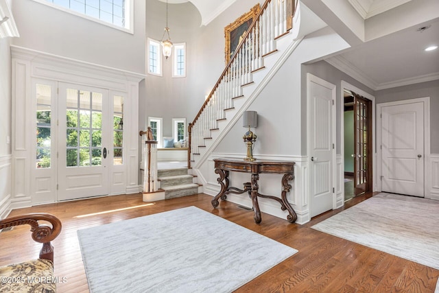 9 Withers Ln, Atlantic Highlands, NJ 07716 - entryway featuring stairway, wood finished floors, a towering ceiling, a decorative wall, and ornamental molding