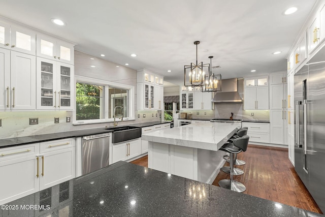 9 Withers Ln, Atlantic Highlands, NJ 07716 - kitchen featuring wall chimney range hood, appliances with stainless steel finishes, white cabinetry, dark stone counters, and backsplash