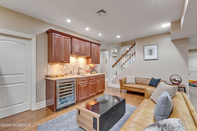 9 Withers Ln, Atlantic Highlands, NJ 07716 - bar featuring beverage cooler, tasteful backsplash, recessed lighting, stairway, and light wood-style flooring