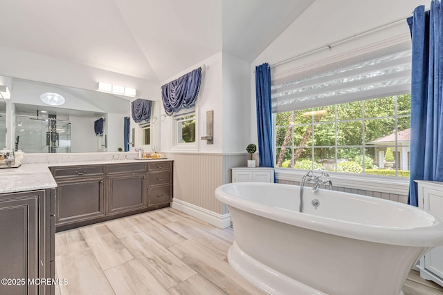 9 Withers Ln, Atlantic Highlands, NJ 07716 - full bathroom with vaulted ceiling, vanity, a freestanding tub, a stall shower, and a wainscoted wall