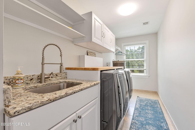 9 Withers Ln, Atlantic Highlands, NJ 07716 - laundry area with independent washer and dryer, cabinet space, and light tile patterned floors