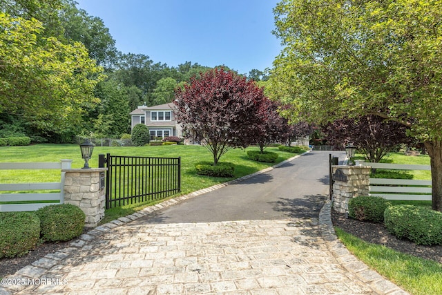 9 Withers Ln, Atlantic Highlands, NJ 07716 - view of front of home featuring decorative driveway and a gate