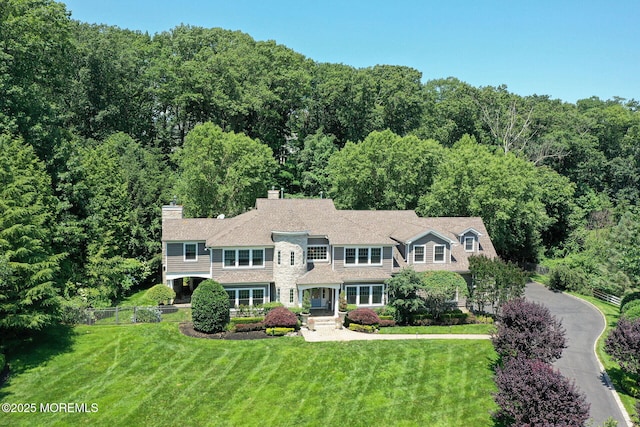 9 Withers Ln, Atlantic Highlands, NJ 07716 - view of front of house featuring a chimney and a wooded view