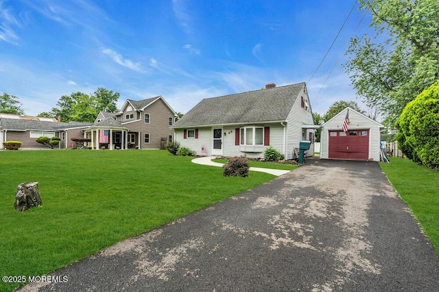 99 Roosevelt Cir E, Red Bank, NJ 07701 - view of front of house featuring an outdoor structure, driveway, a detached garage, and a front yard