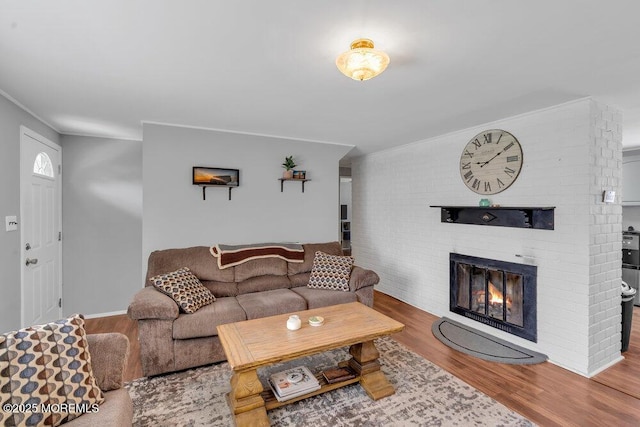 99 Roosevelt Cir E, Red Bank, NJ 07701 - living area with wood finished floors, a brick fireplace, and ornamental molding