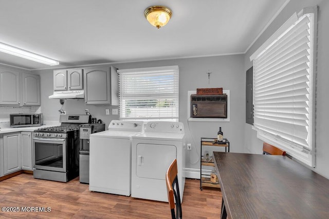 99 Roosevelt Cir E, Red Bank, NJ 07701 - washroom featuring washing machine and clothes dryer, a wall mounted air conditioner, light wood-style flooring, and a baseboard heating unit