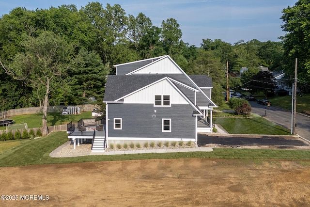 515 Atlantic Ave, Middletown, NJ 07748 - view of side of property featuring a shingled roof, a lawn, and a wooden deck