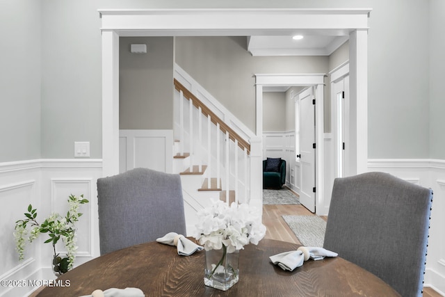 515 Atlantic Ave, Middletown, NJ 07748 - dining area featuring a decorative wall, wood finished floors, wainscoting, and stairs