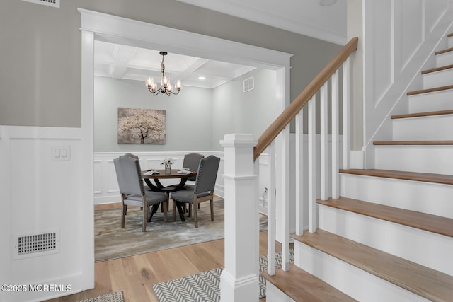 515 Atlantic Ave, Middletown, NJ 07748 - stairway with wood finished floors, a chandelier, beam ceiling, coffered ceiling, and crown molding