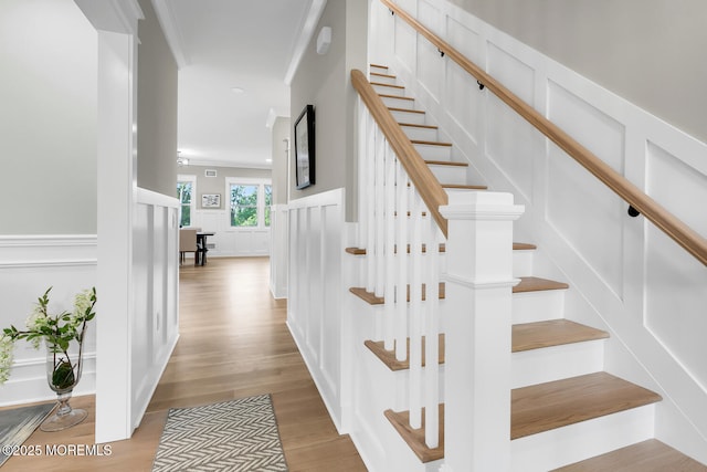 515 Atlantic Ave, Middletown, NJ 07748 - staircase featuring wood finished floors, wainscoting, a decorative wall, and ornamental molding